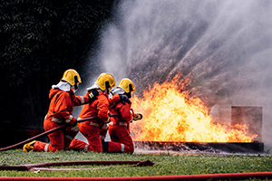 Firefighter Concept. Several firefighters go offensive for a fir